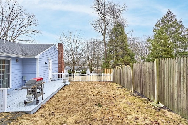 view of yard with a wooden deck and a fenced backyard