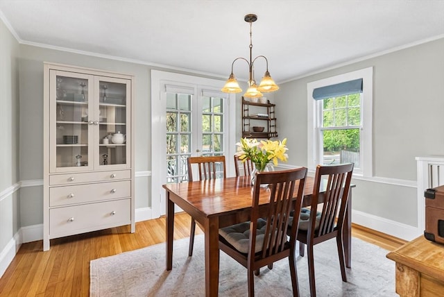 571 Washington St, Winchester, MA 01890 - dining space featuring light wood finished floors, ornamental molding, and baseboards