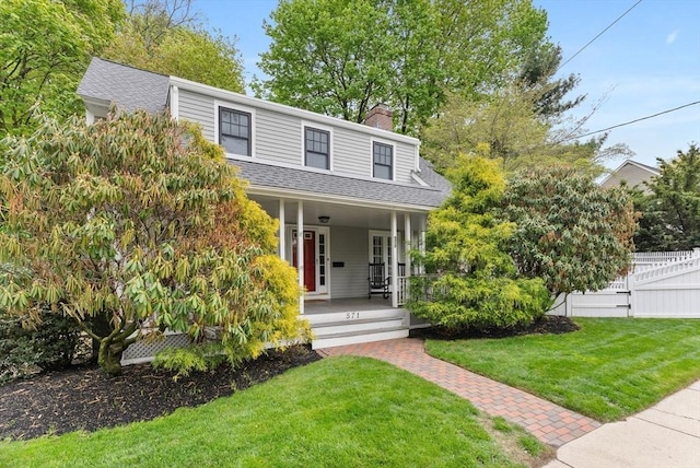 571 Washington St, Winchester, MA 01890 - view of front facade with a porch, a chimney, and a shingled roof