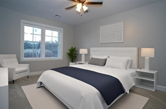 carpeted bedroom with baseboards and a ceiling fan