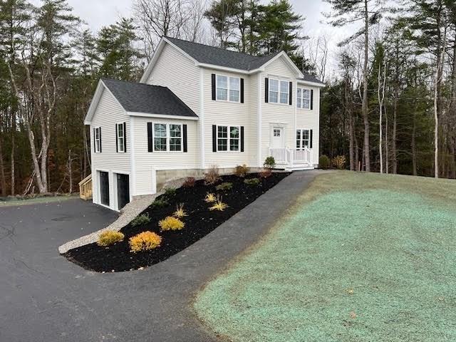 colonial home with driveway and an attached garage