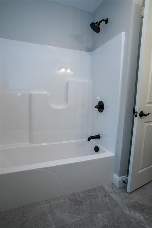 full bathroom featuring marble finish floor and  shower combination