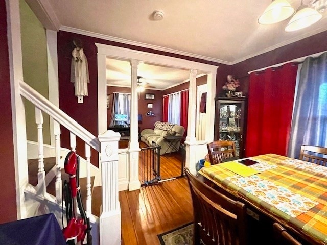 dining area with hardwood / wood-style floors and crown molding