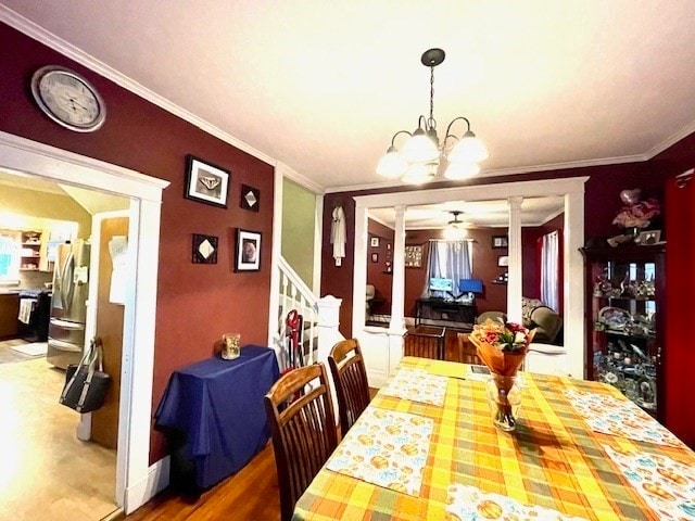 dining area with ceiling fan with notable chandelier, ornate columns, and ornamental molding