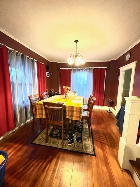 dining space with a chandelier, hardwood / wood-style floors, and ornamental molding