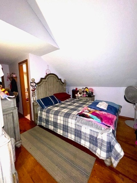 bedroom featuring lofted ceiling and dark wood-type flooring