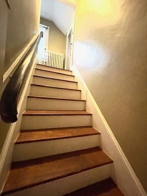 stairway with vaulted ceiling