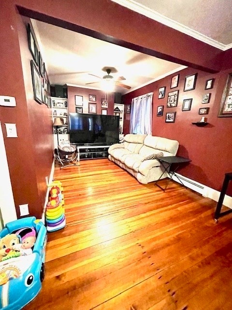 living room with hardwood / wood-style flooring, ceiling fan, and ornamental molding