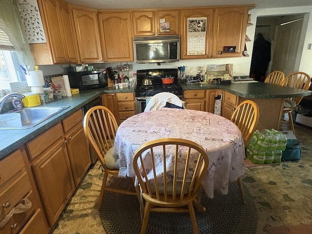 kitchen featuring a kitchen bar, sink, and stainless steel appliances