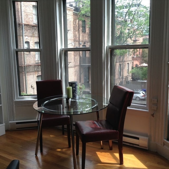 dining room with hardwood / wood-style floors and a baseboard radiator