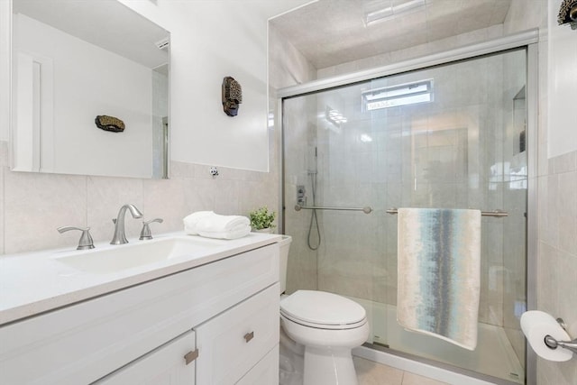 bathroom featuring a shower stall, toilet, vanity, and tile patterned floors