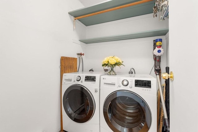 clothes washing area featuring separate washer and dryer
