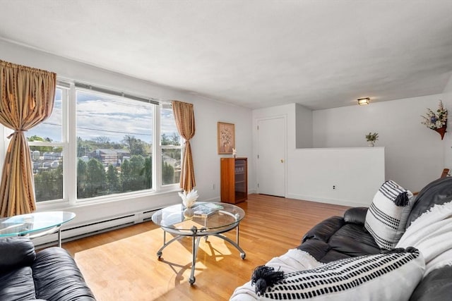living area with light wood-style floors and a baseboard radiator