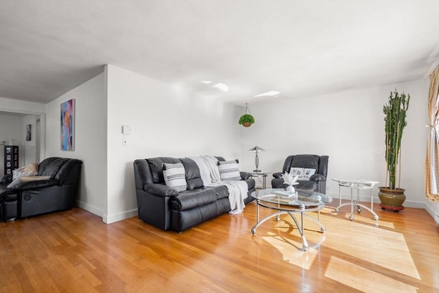 living area with light wood-style floors and baseboards