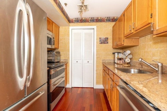 200 Falls Blvd Unit F305, Quincy, MA 02169 - kitchen with stainless steel appliances, a sink, dark wood-style flooring, light stone counters, and tasteful backsplash