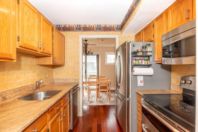 200 Falls Blvd Unit F305, Quincy, MA 02169 - kitchen featuring stainless steel appliances, dark wood-type flooring, a sink, tasteful backsplash, and light stone counters