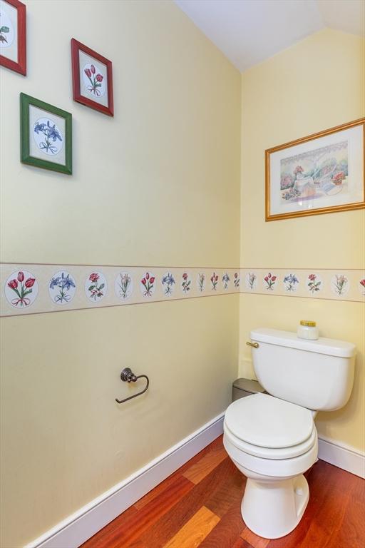 200 Falls Blvd Unit F305, Quincy, MA 02169 - half bath with wood finished floors, toilet, lofted ceiling, and baseboards