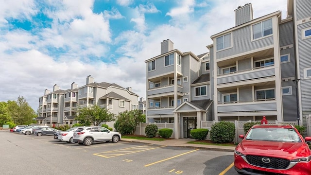 200 Falls Blvd Unit F305, Quincy, MA 02169 - view of building exterior with uncovered parking and a residential view