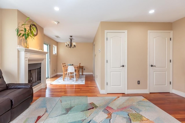 200 Falls Blvd Unit F305, Quincy, MA 02169 - living room featuring wood finished floors, a chandelier, recessed lighting, baseboards, and a fireplace