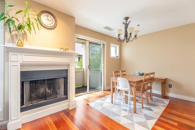 200 Falls Blvd Unit F305, Quincy, MA 02169 - dining space featuring a chandelier, light wood-style flooring, a fireplace, and baseboards