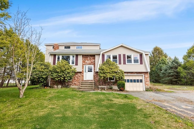 raised ranch featuring driveway, entry steps, a front lawn, brick siding, and a garage