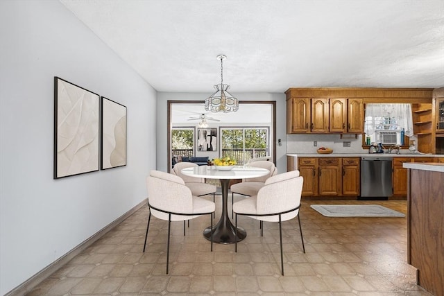 dining room with baseboards and light floors