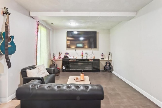 living room with concrete flooring and baseboards