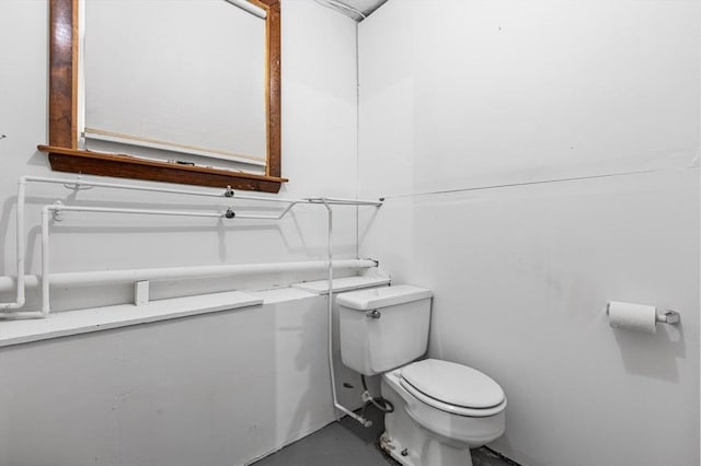 bathroom featuring concrete flooring and toilet