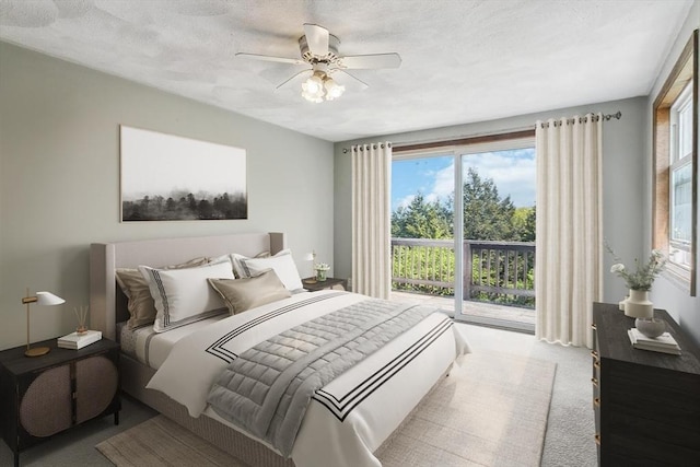 bedroom featuring a textured ceiling, ceiling fan, and carpet flooring
