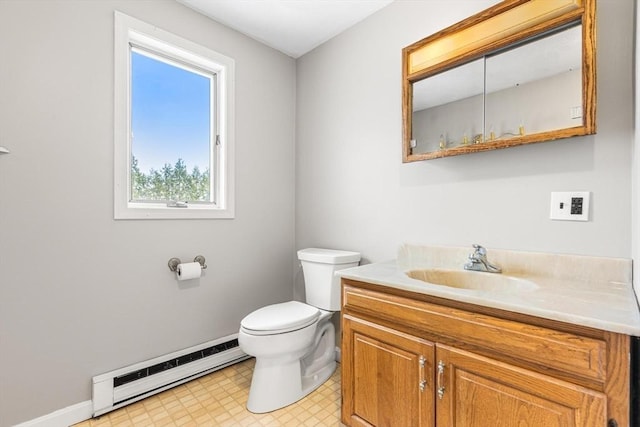 half bath featuring toilet, baseboard heating, vanity, and baseboards