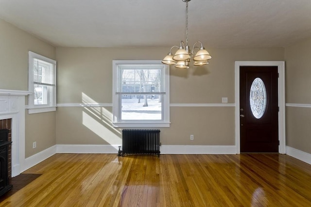 entrance foyer with baseboards, wood finished floors, and radiator