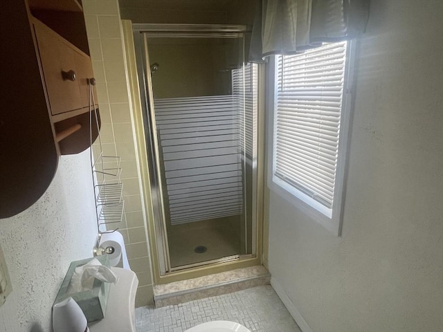 bathroom with tile patterned floors and a shower with shower door