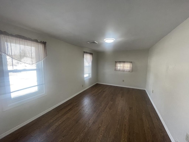 spare room featuring dark hardwood / wood-style floors