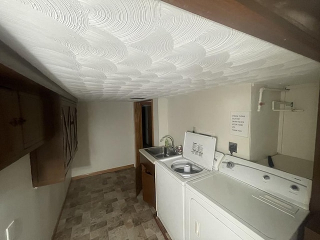 laundry room featuring sink, cabinets, and washing machine and clothes dryer