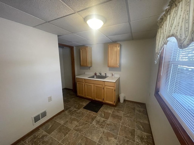 kitchen featuring sink and a drop ceiling