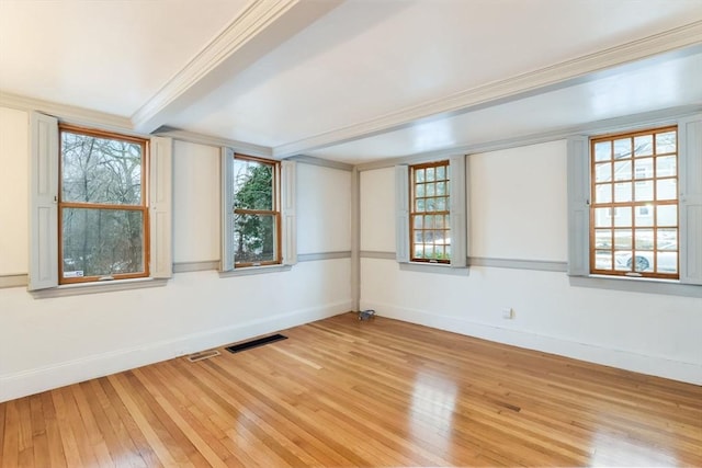 spare room with crown molding, hardwood / wood-style floors, and beam ceiling