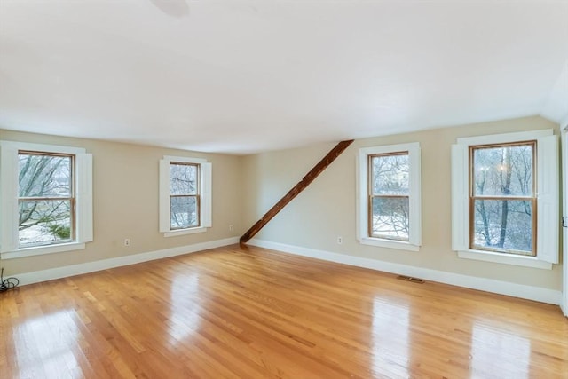 bonus room with light hardwood / wood-style floors