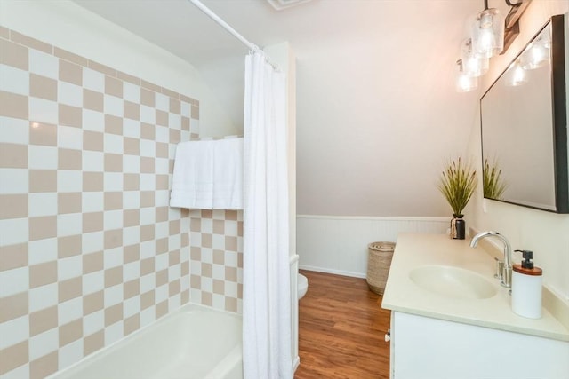 full bathroom featuring vanity, hardwood / wood-style flooring, shower / bath combination with curtain, and toilet