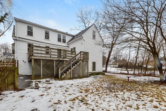 snow covered property featuring a deck