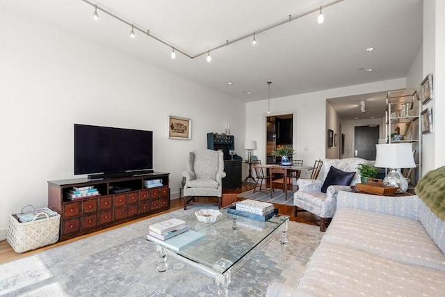 living room featuring track lighting and wood finished floors