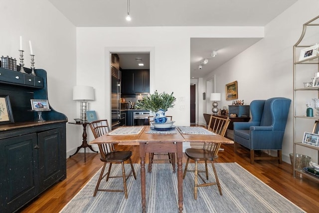 dining room with baseboards and wood finished floors
