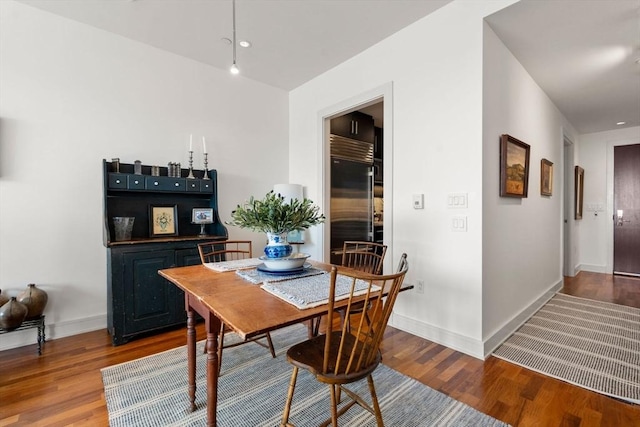 dining room with baseboards, recessed lighting, and wood finished floors