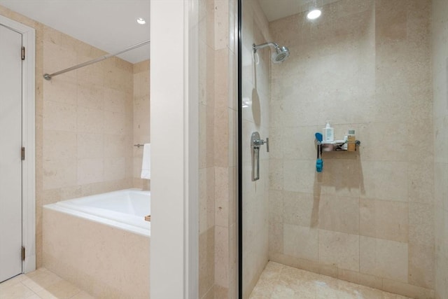 bathroom featuring tile patterned floors, recessed lighting, a shower stall, a bath, and tile walls