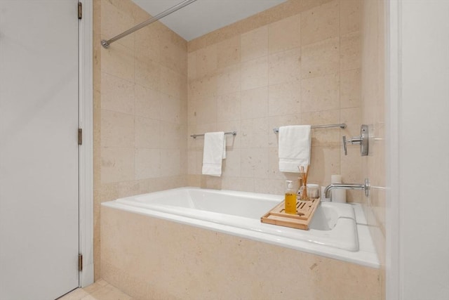 bathroom featuring a bath, tile walls, and walk in shower