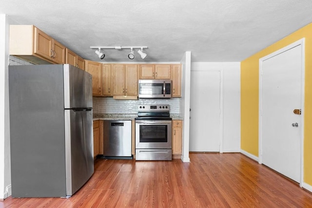 108 Oak Ln Unit 3, Brockton, MA 02301 - kitchen featuring appliances with stainless steel finishes, tasteful backsplash, light wood-style flooring, and light countertops