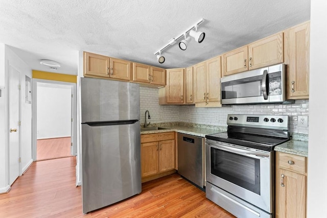 108 Oak Ln Unit 3, Brockton, MA 02301 - kitchen with stainless steel appliances, a sink, light brown cabinetry, light wood finished floors, and a textured ceiling