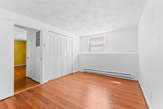 108 Oak Ln Unit 3, Brockton, MA 02301 - unfurnished bedroom with baseboard heating, wood finished floors, electric panel, baseboards, and a closet