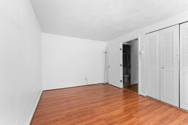 108 Oak Ln Unit 3, Brockton, MA 02301 - unfurnished bedroom featuring light wood-type flooring, baseboards, ensuite bath, and a closet