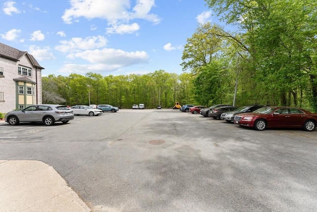 108 Oak Ln Unit 3, Brockton, MA 02301 - uncovered parking lot featuring a forest view