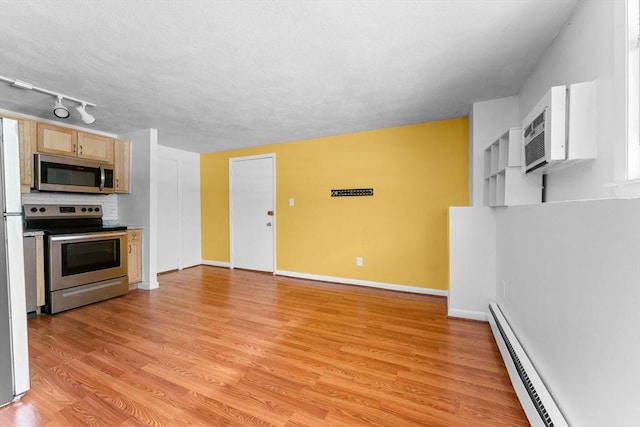108 Oak Ln Unit 3, Brockton, MA 02301 - kitchen with appliances with stainless steel finishes, a baseboard heating unit, light wood finished floors, baseboards, and rail lighting